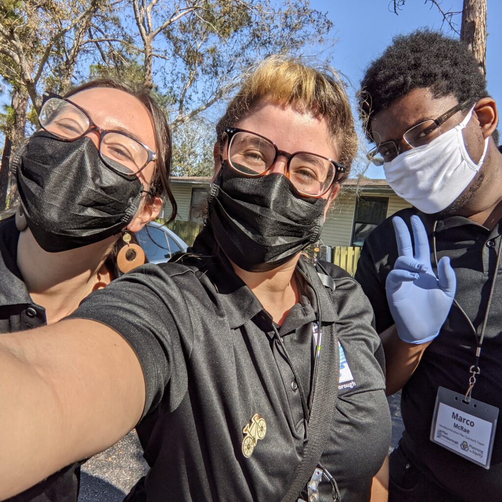 selfie of three community volunteers, wearing face masks