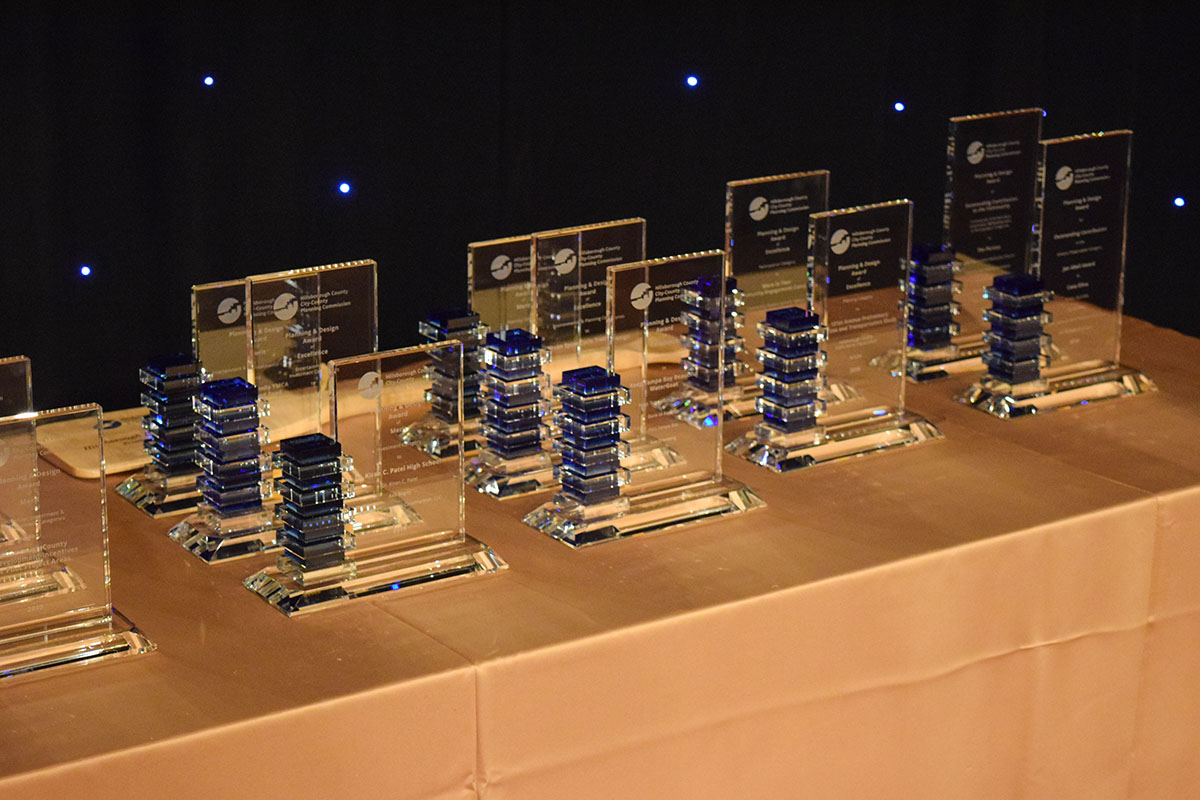 Planning Design Award trophies lined up on a table