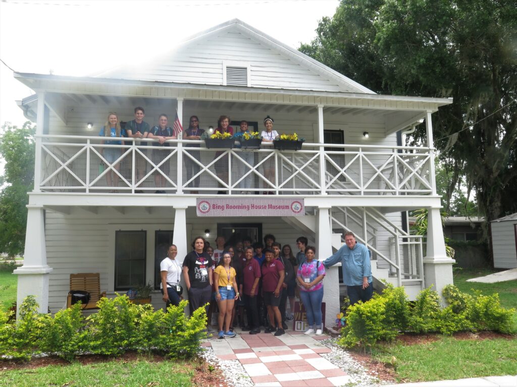 Group of diverse flip students posing for photo at the Bing House in Plant City