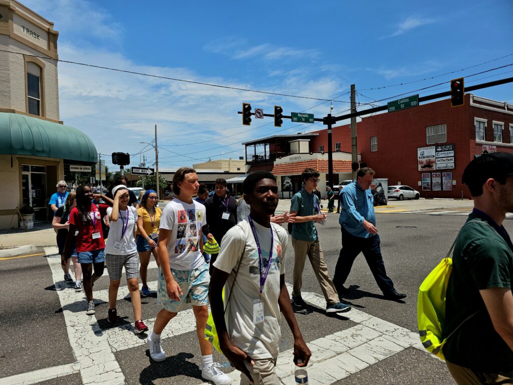 Group of diverse flip students walking across the street in downtown Plant City