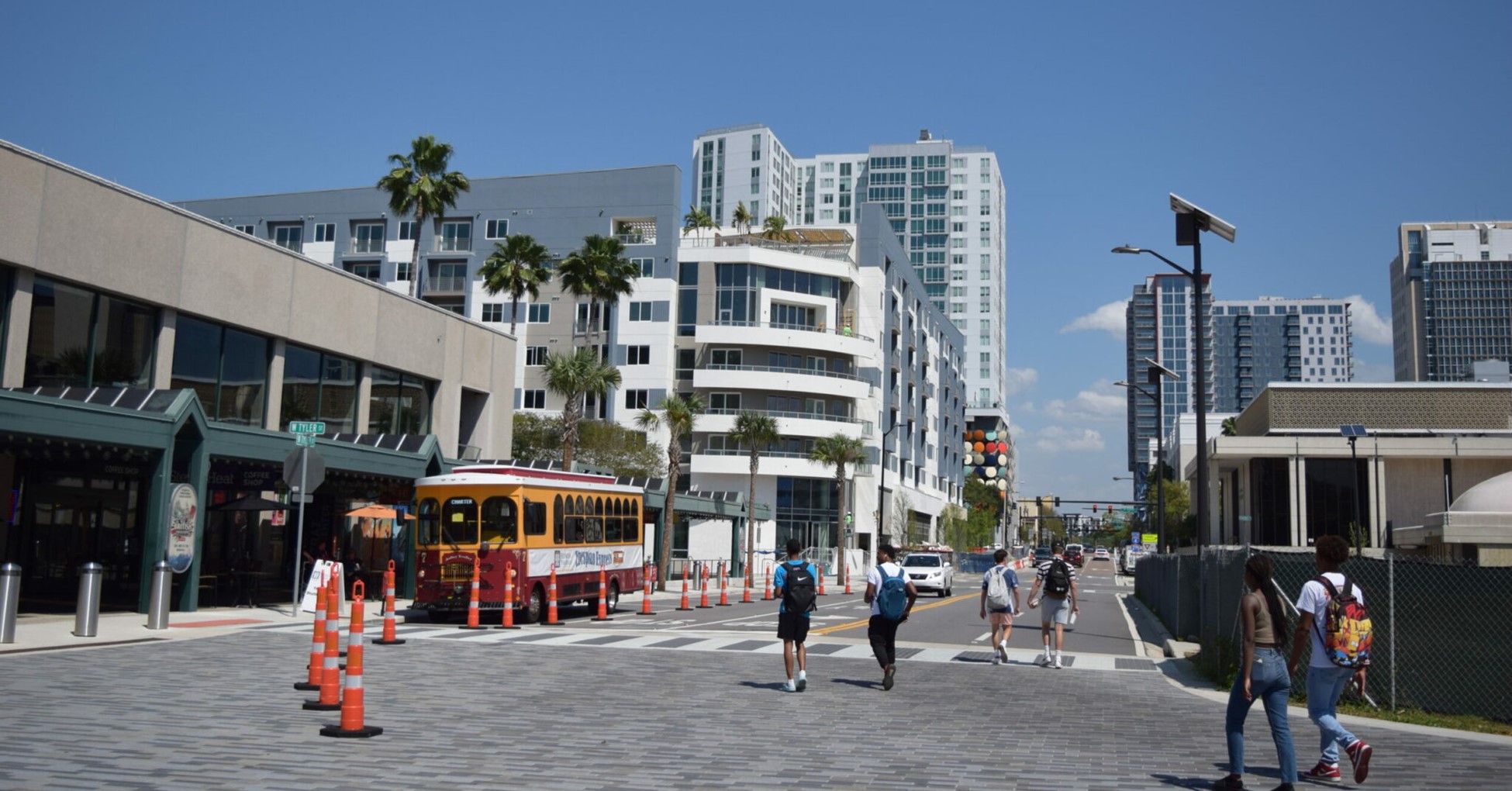 Downtown Tampa street scape with pedestrians, Street Car, and various buildings.